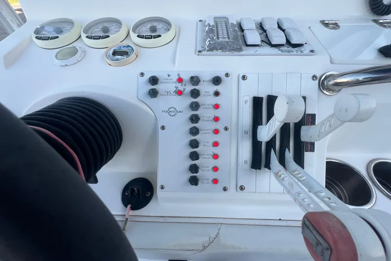 Slide: The Image of Control panel of a 2006 Fountain 23 Center Console boat with gauges and switches. - 47