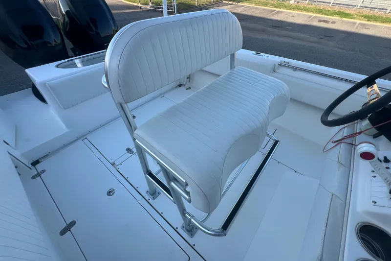 Slide: The Image of 2006 Fountain 23 Center Console boat interior with white seating and steering wheel. - 50