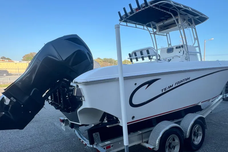 Slide: The Image of 2006 Fountain 23 Center Console boat on trailer, featuring powerful outboard motor. - 7
