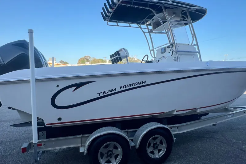 Slide: The Image of 2006 Fountain 23 Center Console boat on trailer, side view, white hull with "Team Fountain" logo. - 8