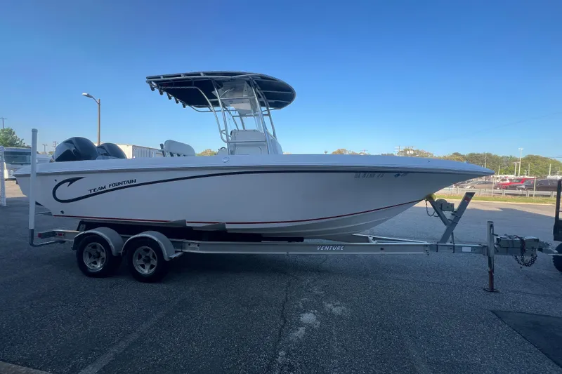 Slide: The Image of 2006 Fountain 23 Center Console boat on trailer under clear blue sky. - 9