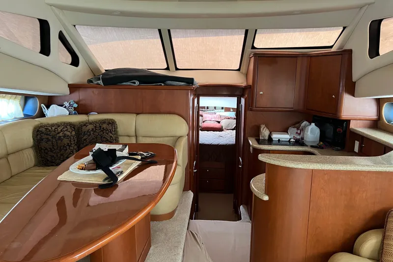 Slide: The Image of Interior of 2006 Silverton 38 Sport Bridge yacht with cozy seating and kitchenette. - 11