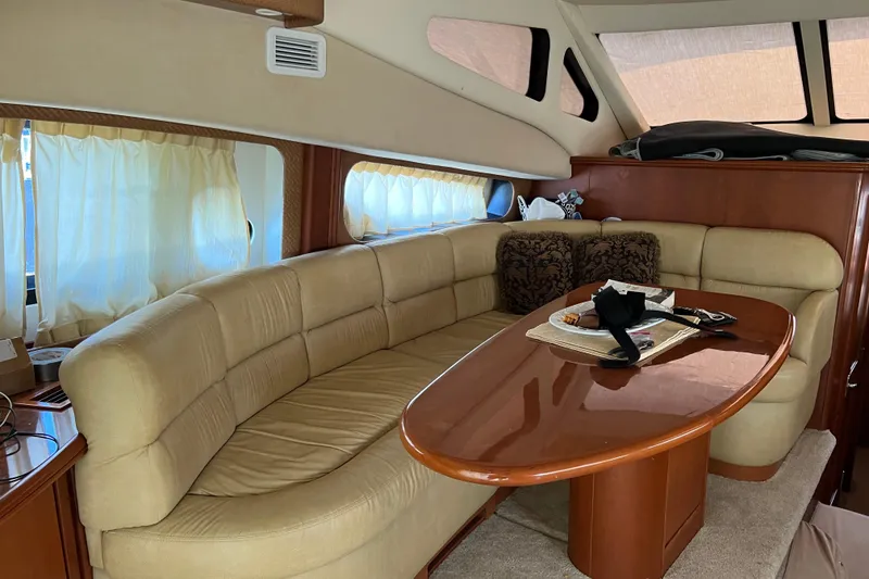 Slide: The Image of Luxurious interior of a 2006 Silverton 38 Sport Bridge yacht with plush seating and elegant table. - 12