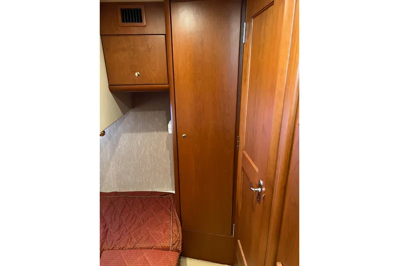 Slide: The Image of Interior cabin of 2006 Silverton 38 Sport Bridge with wooden cabinetry and door. - 17