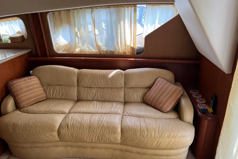 Slide: The Image of Luxurious interior of 2006 Silverton 38 Sport Bridge with beige sofa and decorative pillows. - 20