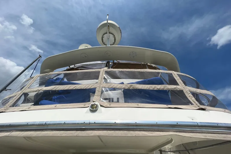 Slide: The Image of 2006 Silverton 38 Sport Bridge yacht under a clear blue sky. - 29