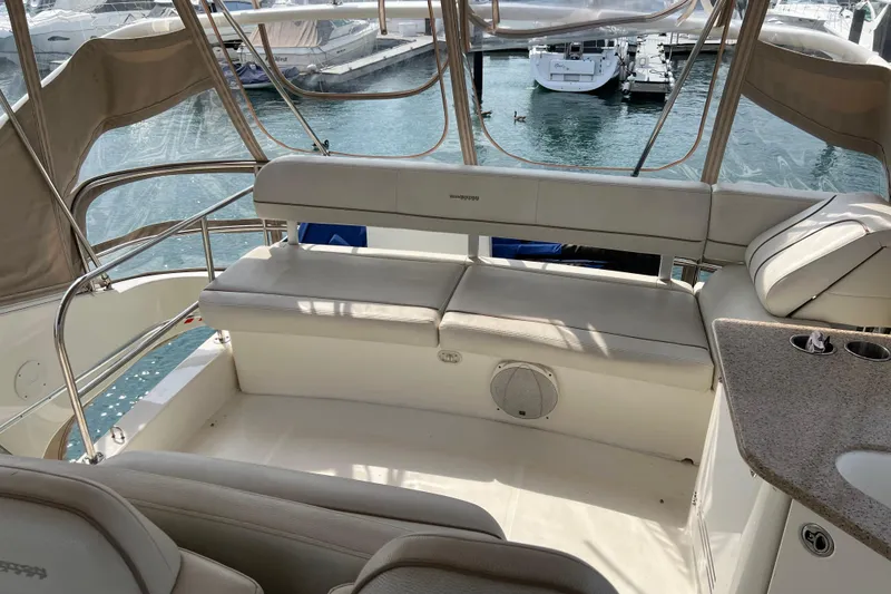 Slide: The Image of 2006 Silverton 38 Sport Bridge yacht interior with seating and water view. - 3