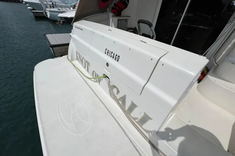 Slide: The Image of 2006 Silverton 38 Sport Bridge yacht docked, featuring "Knot On Call" and "Chicago" on the stern. - 30