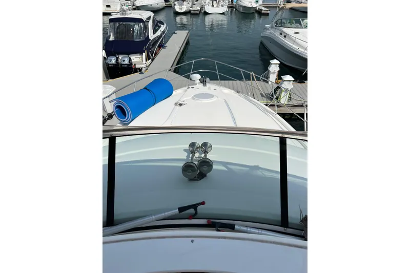 Slide: The Image of 2006 Silverton 38 Sport Bridge yacht docked at marina with blue mat on deck. - 5