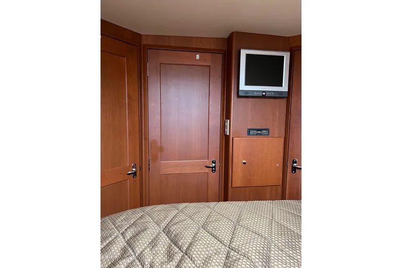 Slide: The Image of Interior of 2006 Silverton 38 Sport Bridge with wood paneling and mounted TV. - 7