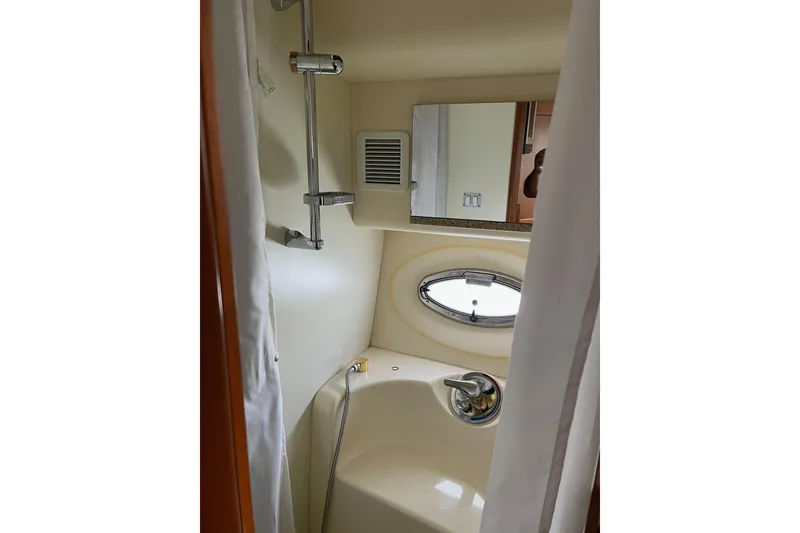 Slide: The Image of Bathroom interior of 2006 Silverton 38 Sport Bridge yacht with shower and porthole window. - 8