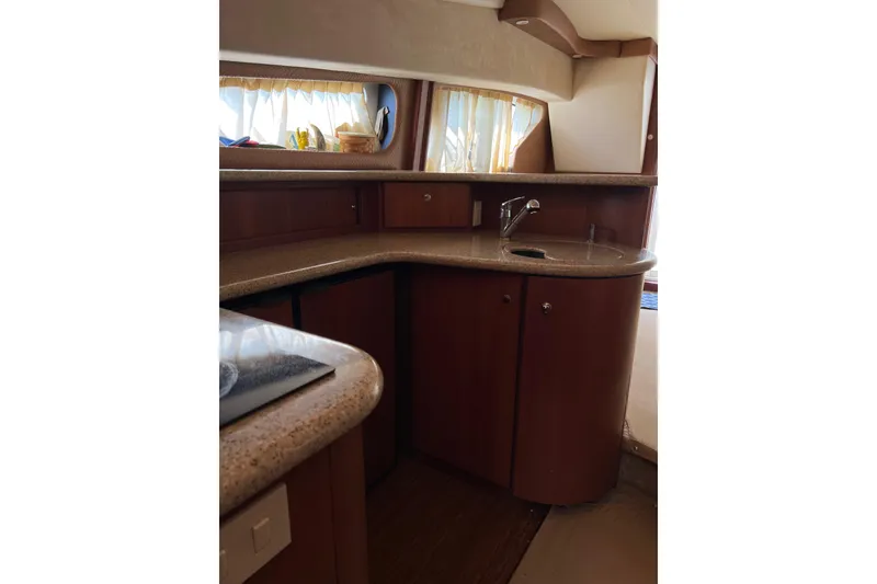Slide: The Image of Interior of 2006 Silverton 38 Sport Bridge yacht with wooden cabinetry and countertop. - 9