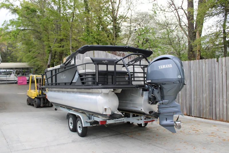 Slide: The Image of 2023 SunChaser Geneva Sport 23 SB pontoon boat on trailer with Yamaha outboard motor. - 1
