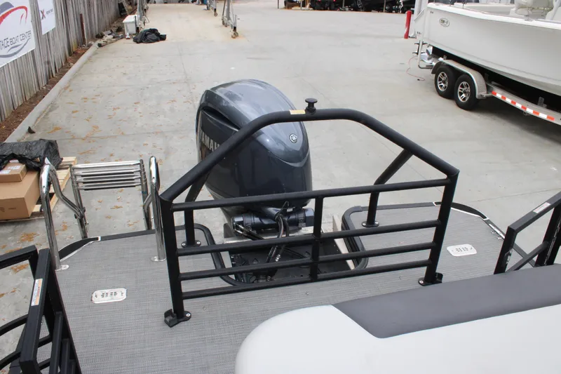 Slide: The Image of 2023 SunChaser Geneva Sport 23 SB pontoon boat with Yamaha outboard motor, docked on concrete. - 15