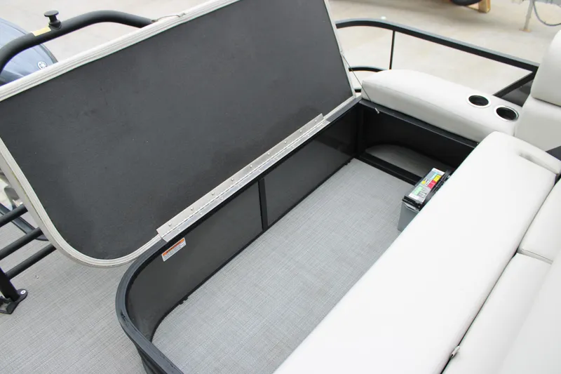 Slide: The Image of 2023 SunChaser Geneva Sport 23 SB boat storage compartment with open seat and cup holders. - 16