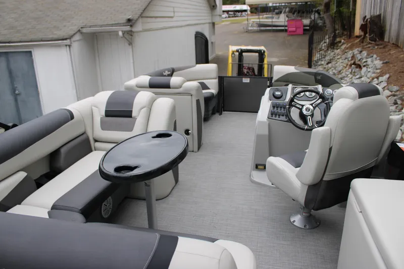 Slide: The Image of 2023 SunChaser Geneva Sport 23 SB pontoon boat interior with plush seating and steering console. - 17
