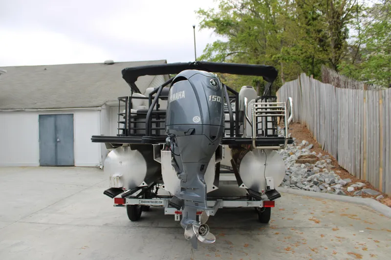 Slide: The Image of 2023 SunChaser Geneva Sport 23 SB pontoon boat with Yamaha outboard motor. - 2