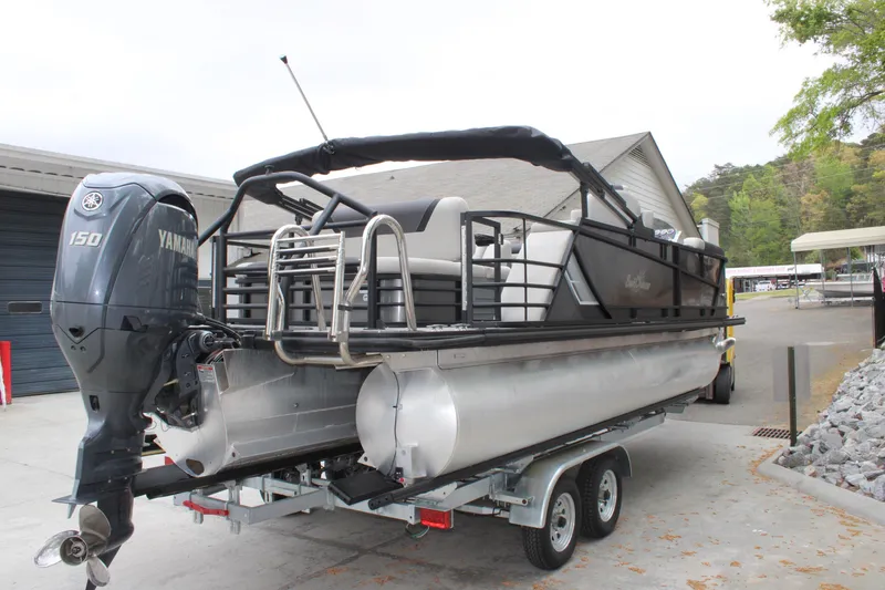 Slide: The Image of 2023 SunChaser Geneva Sport 23 SB pontoon boat on trailer with Yamaha 150 engine. - 3