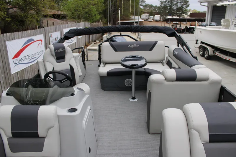 Slide: The Image of 2023 SunChaser Geneva Sport 23 SB pontoon boat interior with plush seating and steering console. - 5