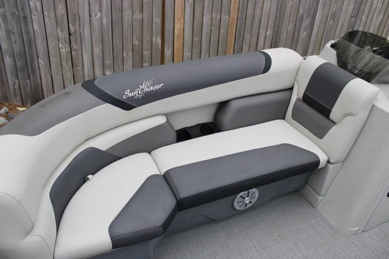 Slide: The Image of 2023 SunChaser Geneva Sport 23 SB boat seating, gray and white upholstery, outdoor setting. - 6