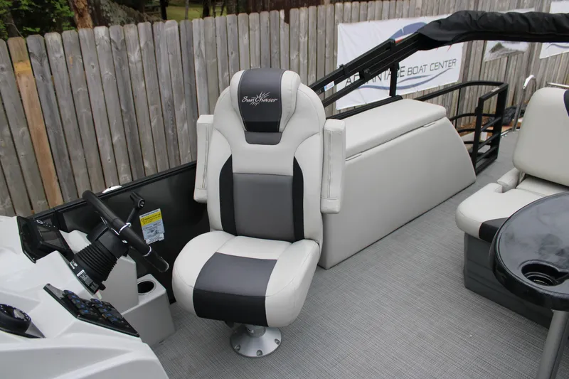 Slide: The Image of 2023 SunChaser Geneva Sport 23 SB boat interior with captain's chair and steering console. - 8