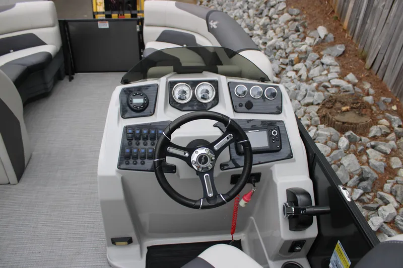 Slide: The Image of 2023 SunChaser Geneva Sport 23 SB boat dashboard with steering wheel and controls. - 9