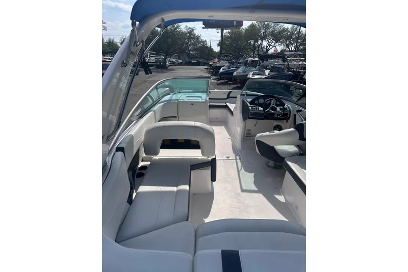 Slide: The Image of 2018 Regal 22 FasDeck boat interior with seating and steering console. - 14