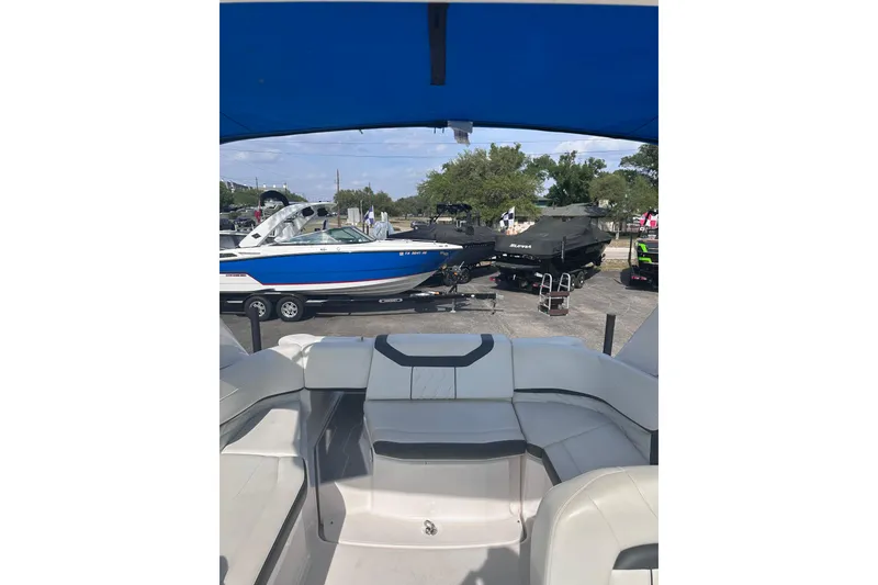 Slide: The Image of 2018 Regal 22 FasDeck boat interior with view of other boats in a marina setting. - 16