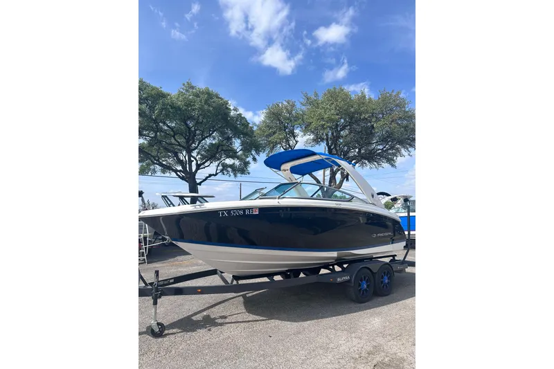 Slide: The Image of 2018 Regal 22 FasDeck boat interior with white seating and cup holders. - 17