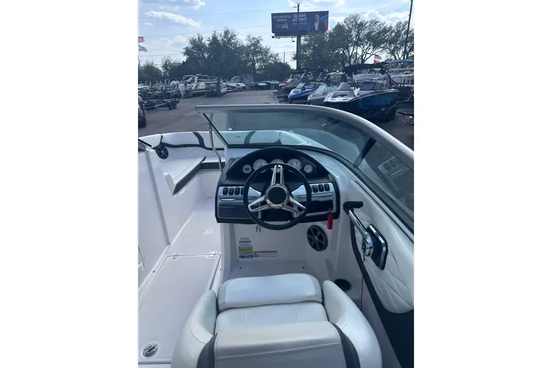 Slide: The Image of 2018 Regal 22 FasDeck boat interior with steering wheel and dashboard controls. - 19