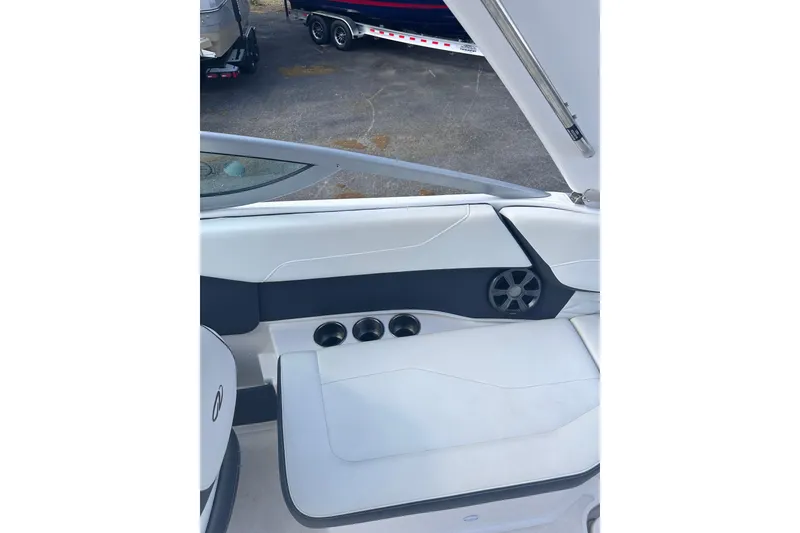 Slide: The Image of 2018 Regal 22 FasDeck boat interior with white seating and cup holders. - 24