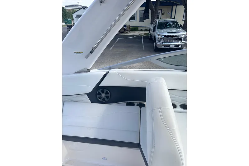 Slide: The Image of 2018 Regal 22 FasDeck boat interior with white seating and speaker detail. - 26