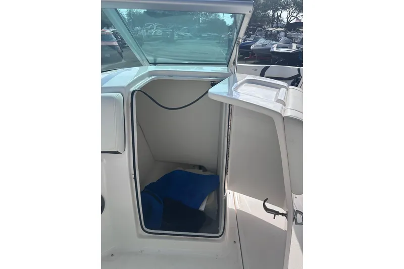 Slide: The Image of 2018 Regal 22 FasDeck boat interior storage compartment with open door. - 27