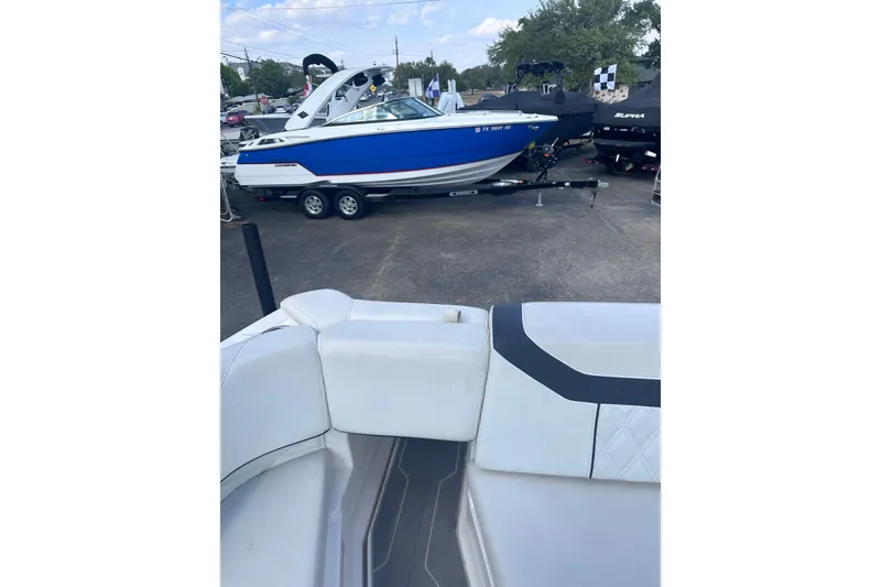 Slide: The Image of 2018 Regal 22 FasDeck boat on trailer, blue and white exterior, parked outdoors. - 33