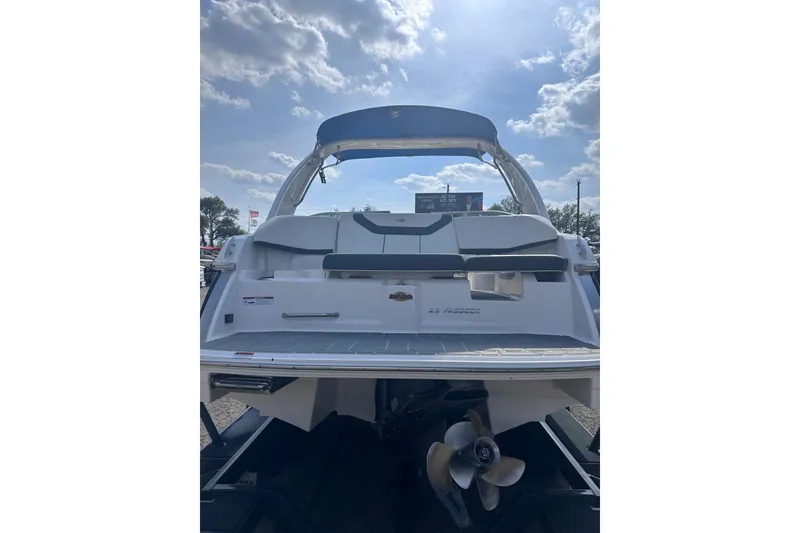 Slide: The Image of 2018 Regal 22 FasDeck boat, rear view with propeller, under a partly cloudy sky. - 6