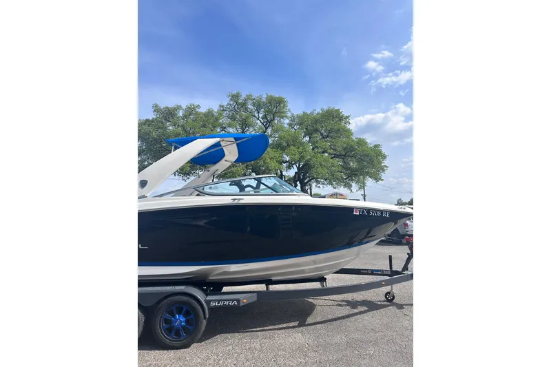 Slide: The Image of 2018 Regal 22 FasDeck boat on trailer under clear blue sky. - 8