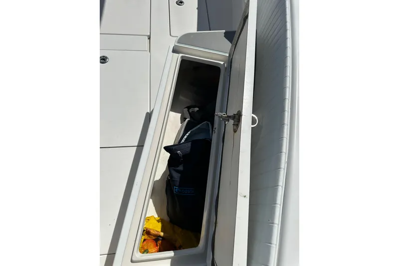 Slide: The Image of Open storage compartment on 2008 Contender 31 Tournament boat with gear inside. - 11