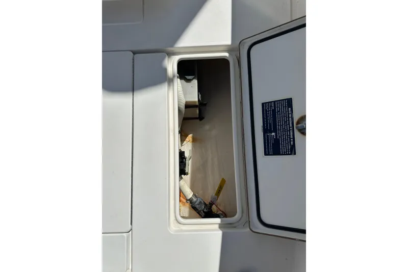 Slide: The Image of Open hatch on 2008 Contender 31 Tournament boat, revealing interior compartment. - 12