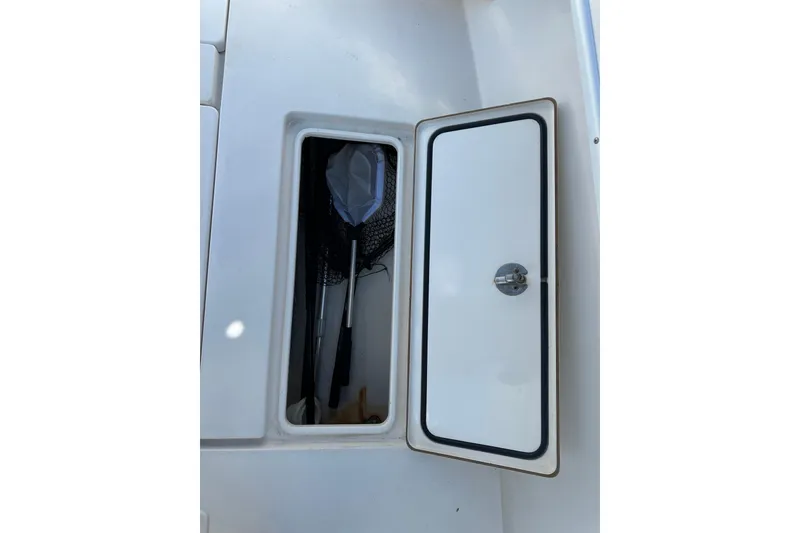 Slide: The Image of Storage compartment on a 2008 Contender 31 Tournament boat, containing fishing gear. - 14