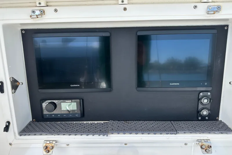 Slide: The Image of 2008 Contender 31 Tournament boat dashboard with dual Garmin displays and Fusion audio system. - 19