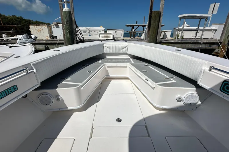 Slide: The Image of 2008 Contender 31 Tournament boat interior with seating and storage, docked under clear skies. - 20