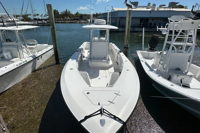 Slide: The Image of 2008 Contender 31 Tournament boat docked at marina, surrounded by watercraft. - 21