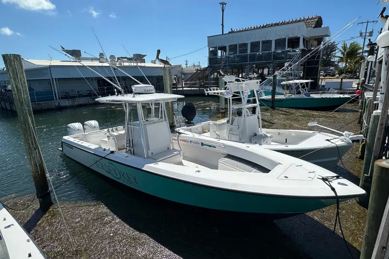 Slide: The Image of 2008 Contender 31 Tournament boat docked at marina under clear blue sky. - 23