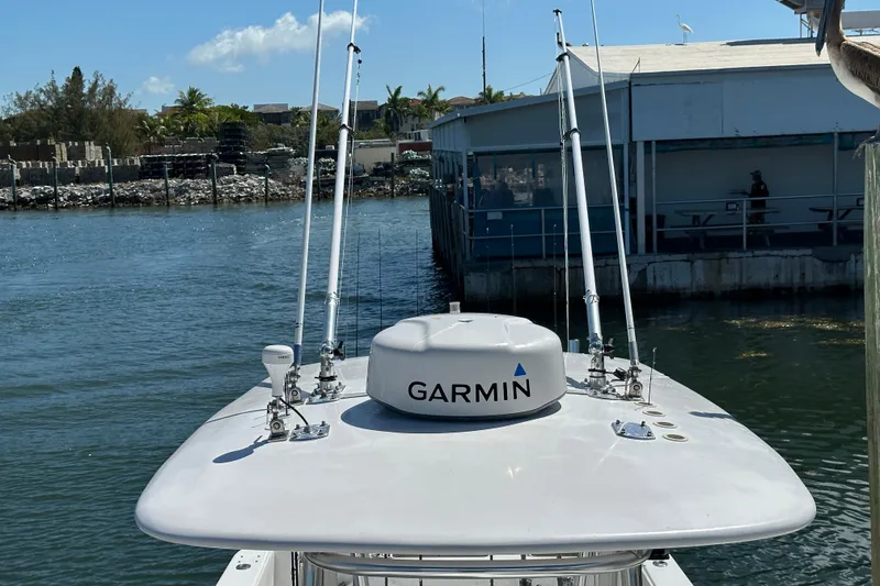 Slide: The Image of 2008 Contender 31 Tournament boat with Garmin equipment docked by a marina. - 25