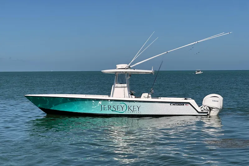 Slide: The Image of 2008 Contender 31 Tournament boat on calm ocean waters, featuring fishing rods and Yamaha engines. - 3