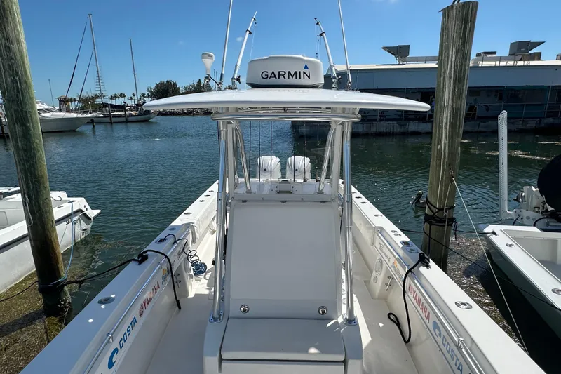 Slide: The Image of 2008 Contender 31 Tournament boat docked, featuring Garmin equipment, clear sky, and marina backdrop. - 4