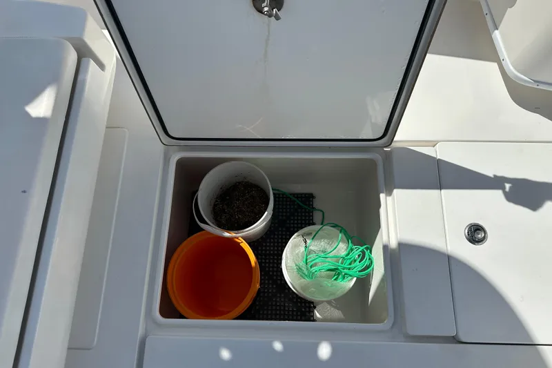 Slide: The Image of Storage compartment on a 2008 Contender 31 Tournament boat with buckets and rope. - 7