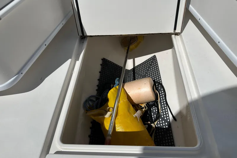 Slide: The Image of Storage compartment on a 2008 Contender 31 Tournament boat with cleaning tools and equipment. - 8