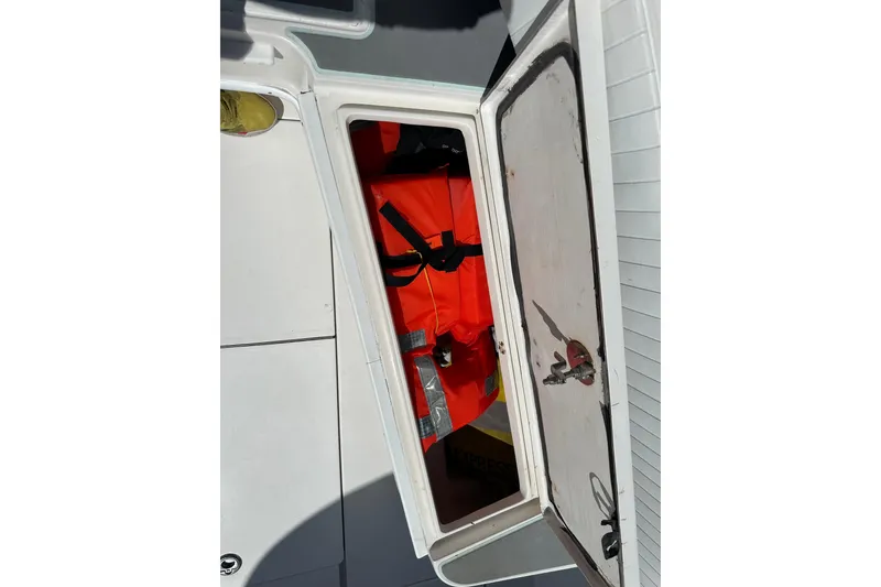 Slide: The Image of Open storage compartment on 2008 Contender 31 Tournament boat with life jackets inside. - 9
