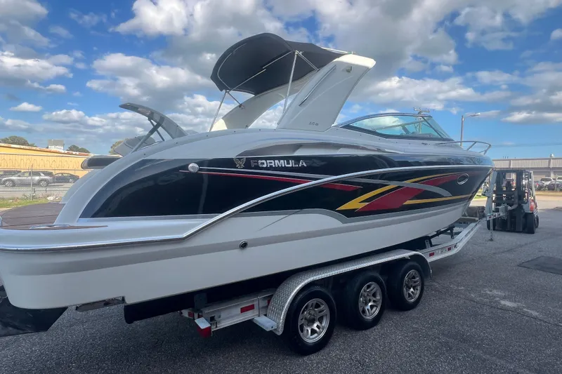 Slide: The Image of 2008 Formula 310 Sun Sport boat on trailer under blue sky. - 10
